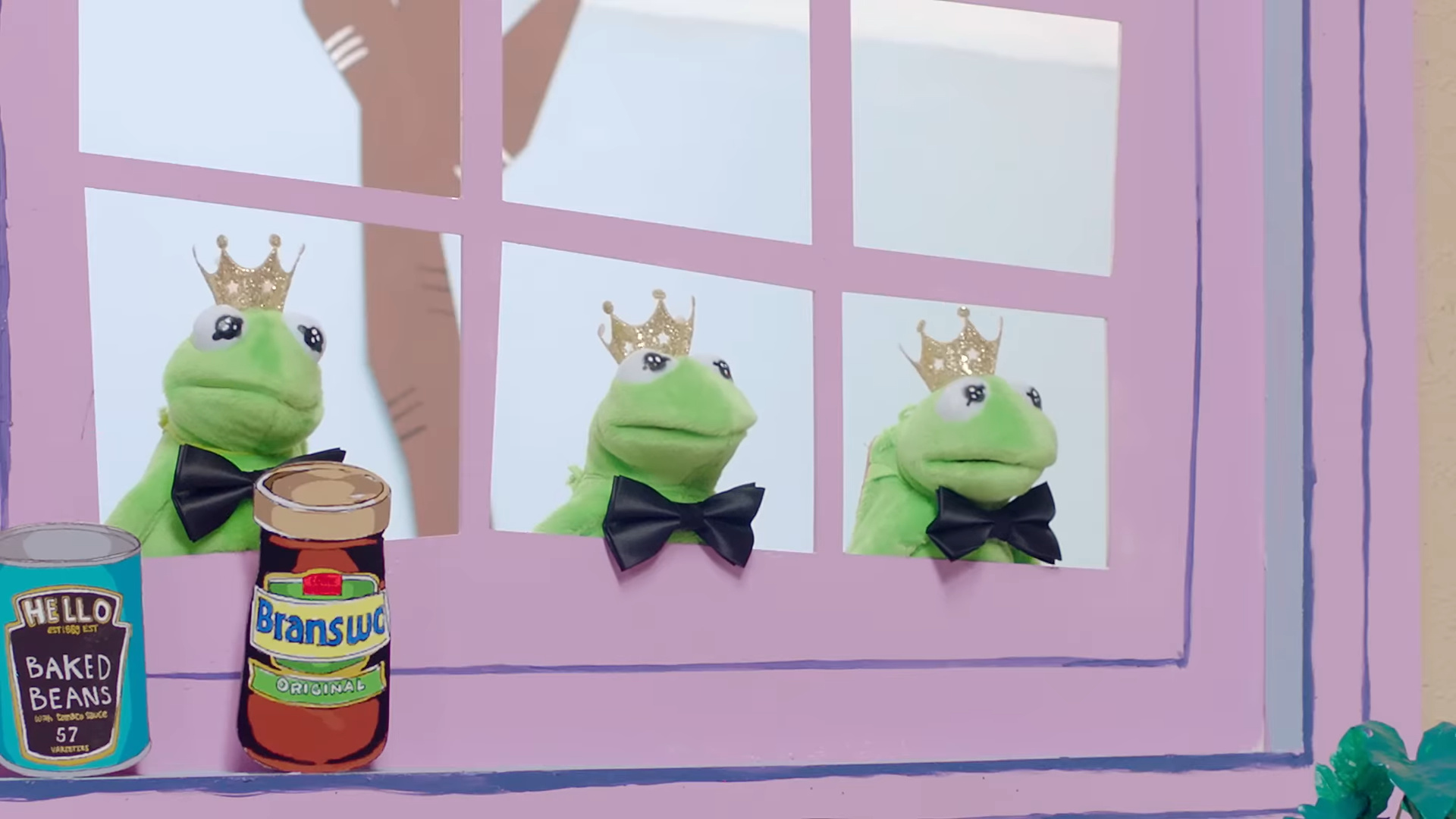 Two cans in front of the frog puppets.